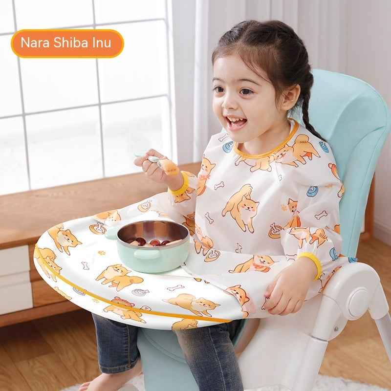Child sitting in a high chair with a tray and bowl, wearing a shirt with animal prints.