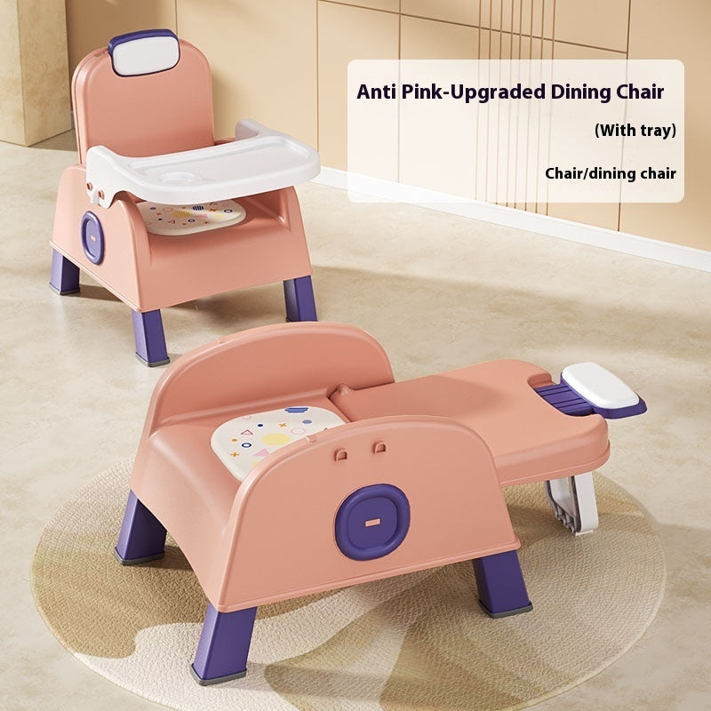 Pink and purple children's dining chair with tray on a beige floor.