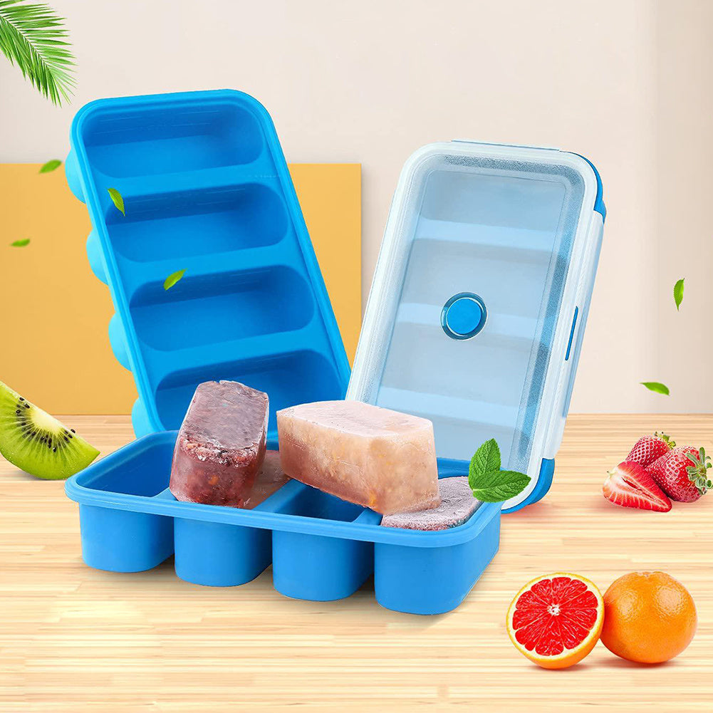Blue silicone ice cube tray with frozen cubes on a wooden surface with fruits.