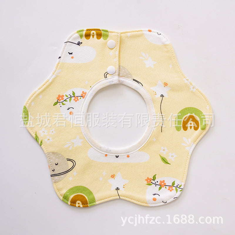 Yellow baby bib with cartoon designs on a white background