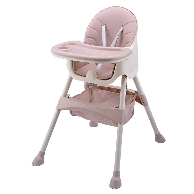 Pink baby high chair with tray on a white background