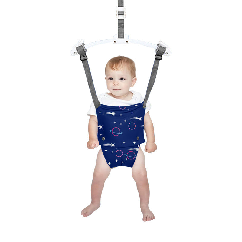 Baby in a space-themed romper with a harness on a white background
