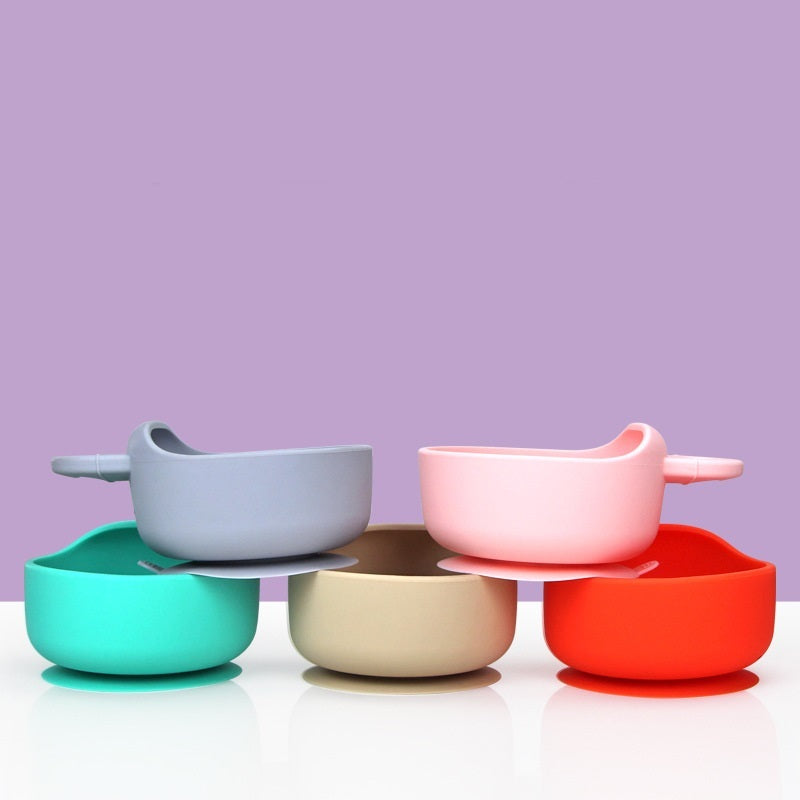 Set of colorful bowls on a white surface with a purple background