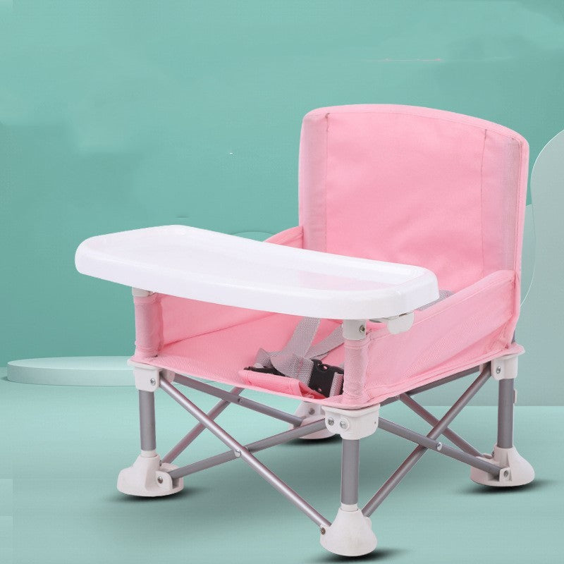 Pink and white baby high chair on a teal background