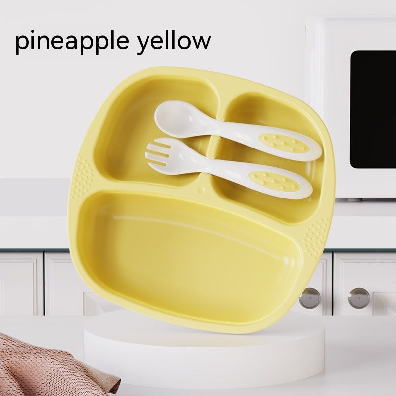 Yellow children's plate with white utensils on a white background