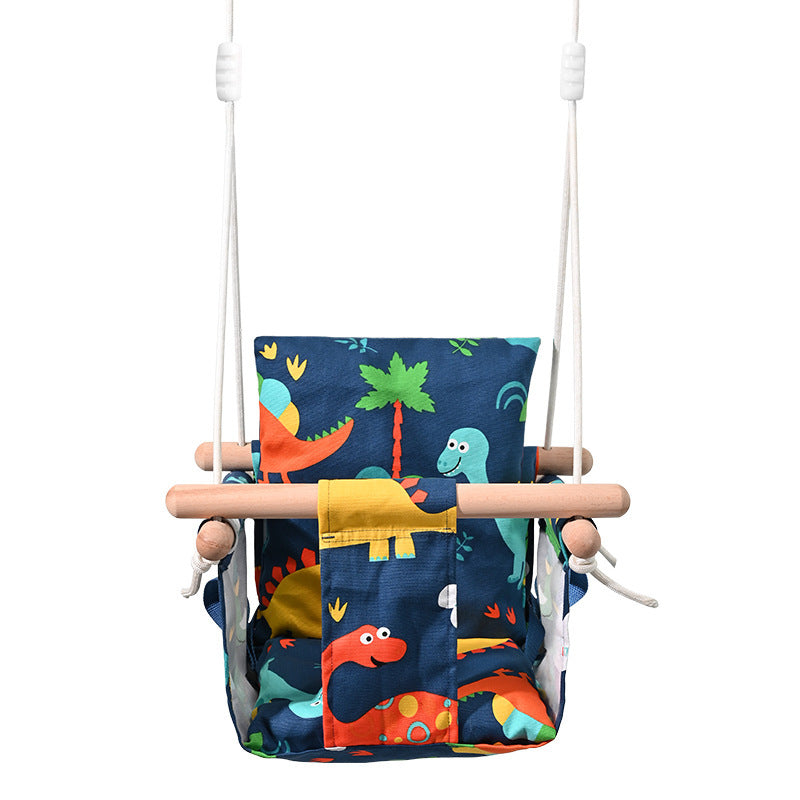 Children's swing with dinosaur patterned seat on a white background