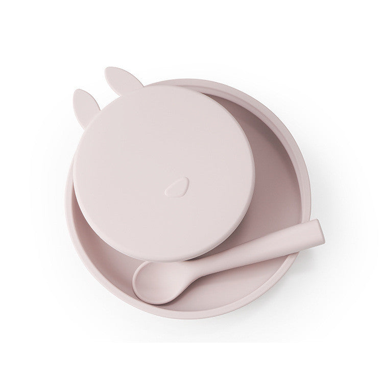 Pink children's bowl, spoon, and lid set on a white background