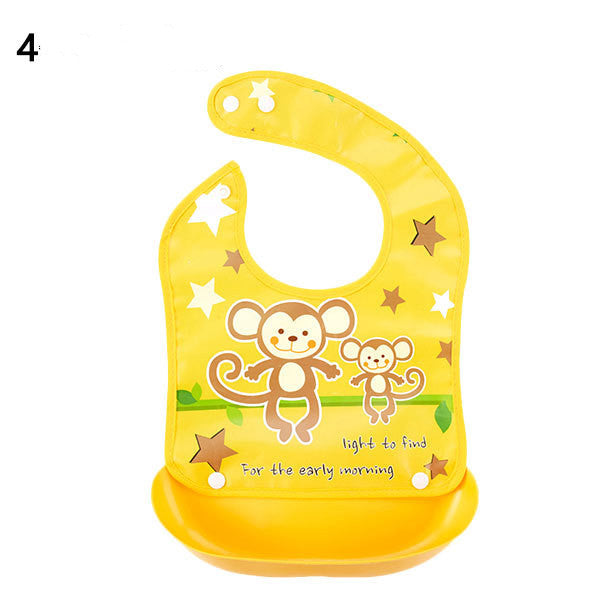 Yellow baby bib with monkey design on a white background