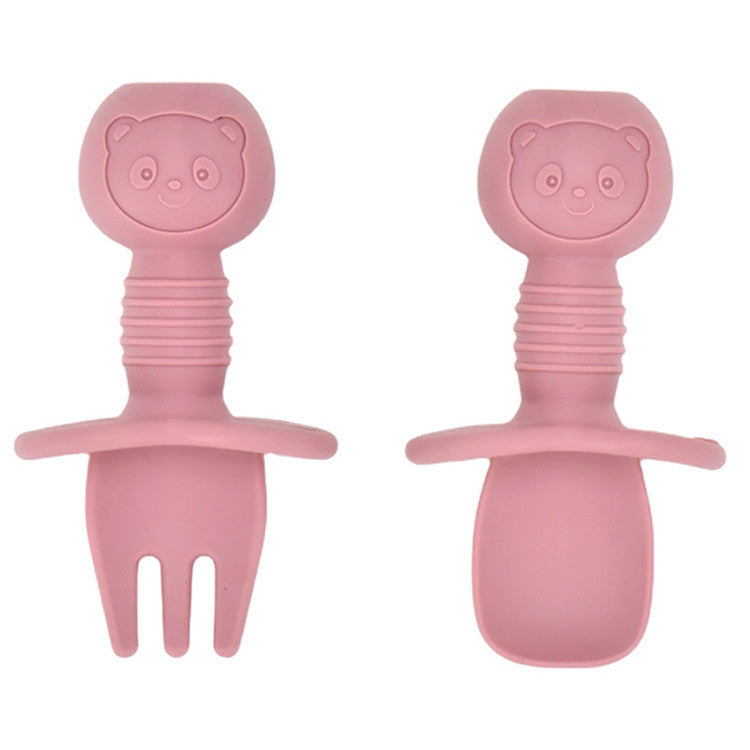 Two pink silicone baby utensils with bear faces on a white background