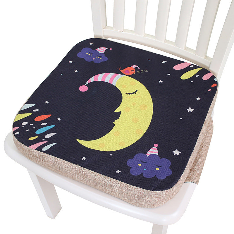 Decorative seat cushion with a moon and star design on a white chair.