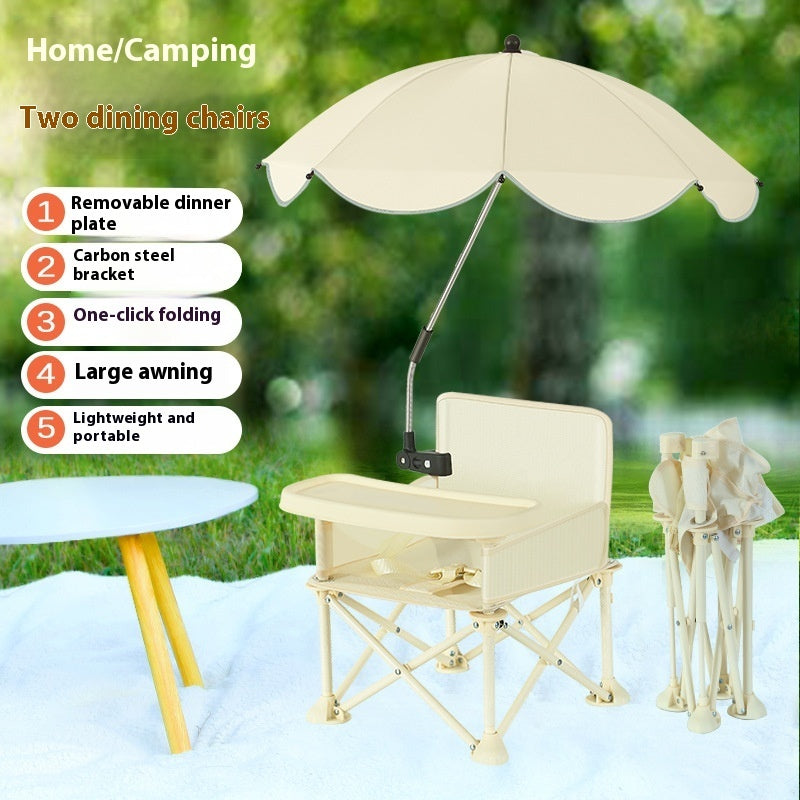 Beige camping chair with umbrella and table on a grassy background
