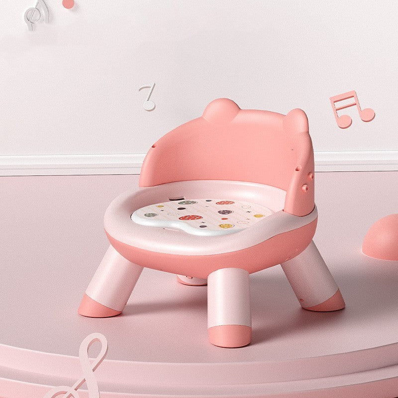 Pink children's chair with a white seat on a light pink background
