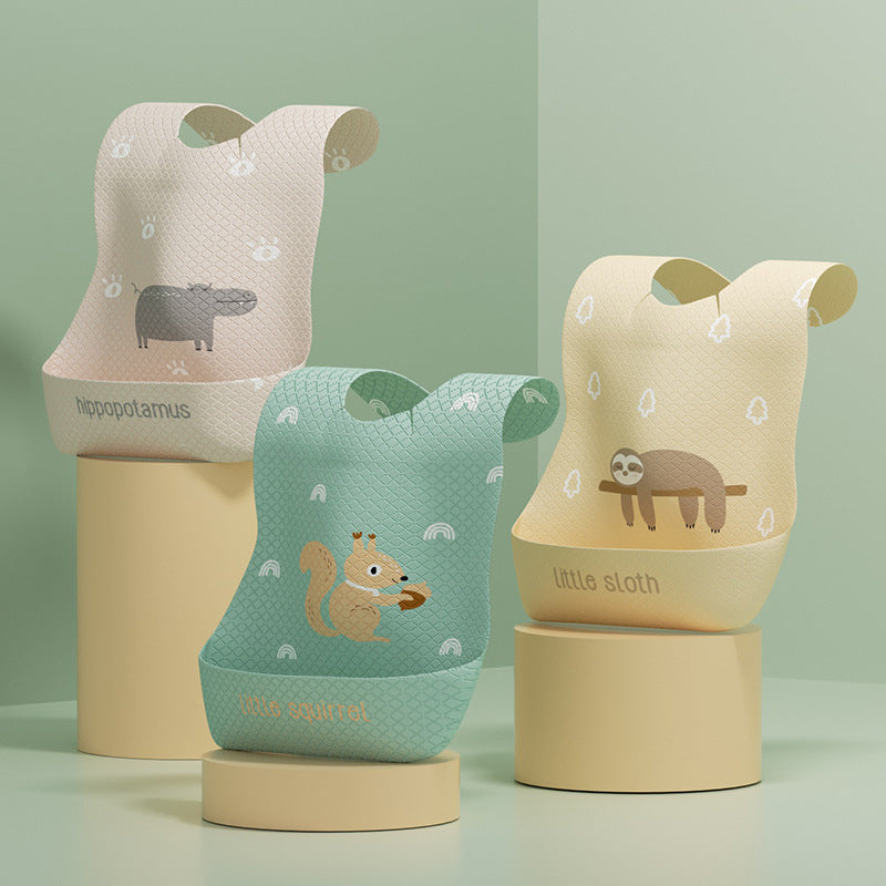 Three children's bibs with animal illustrations on a light green background