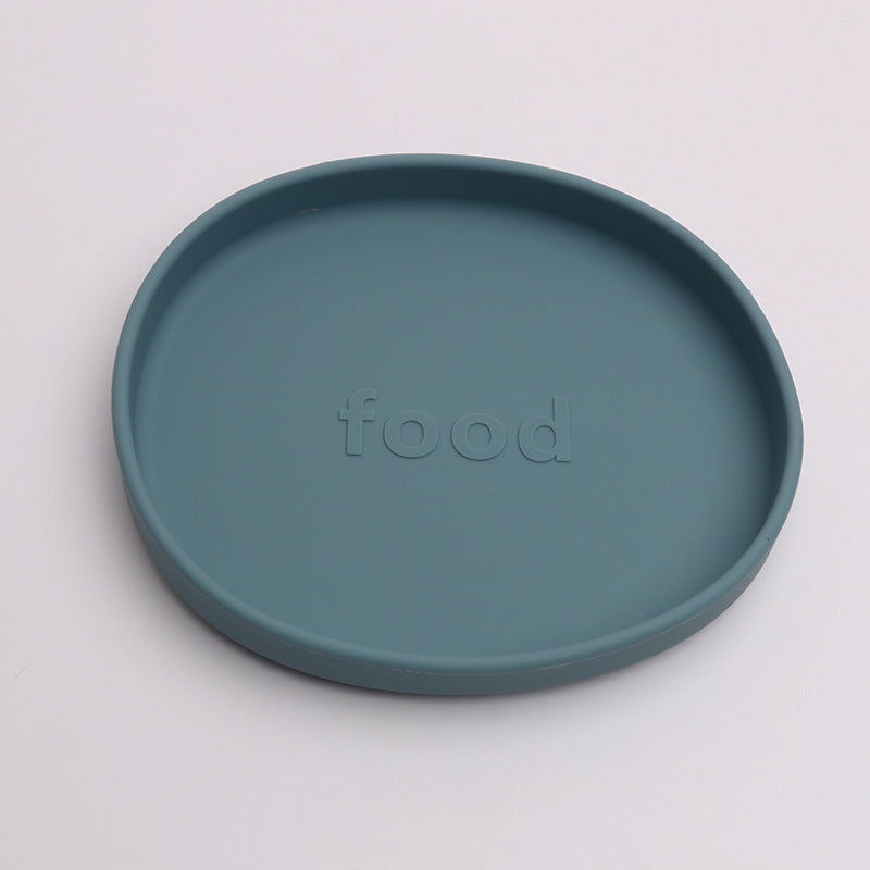 Teal plate with 'food' embossed on a light gray background