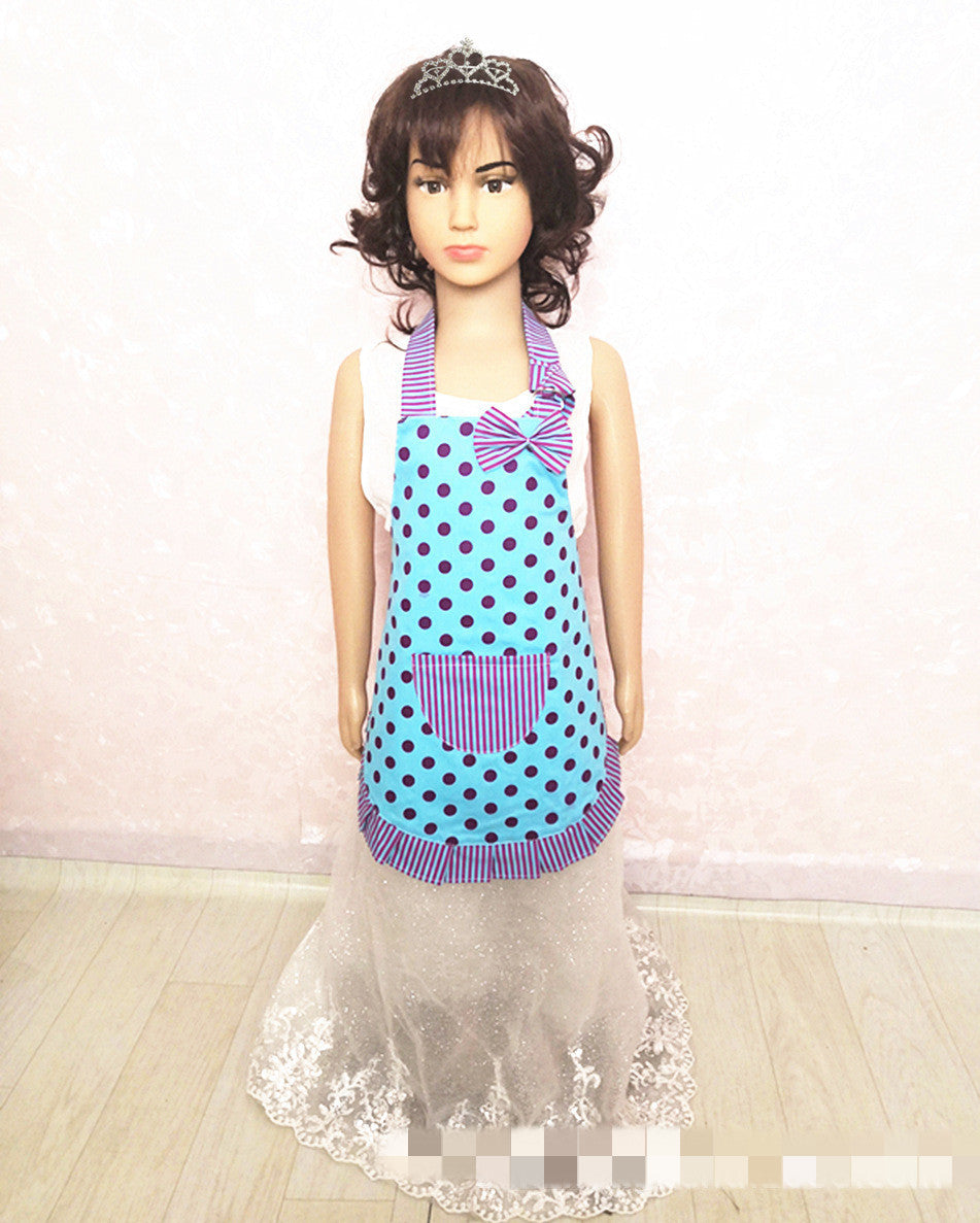 Mannequin wearing a blue polka dot apron with a purple border on a white background