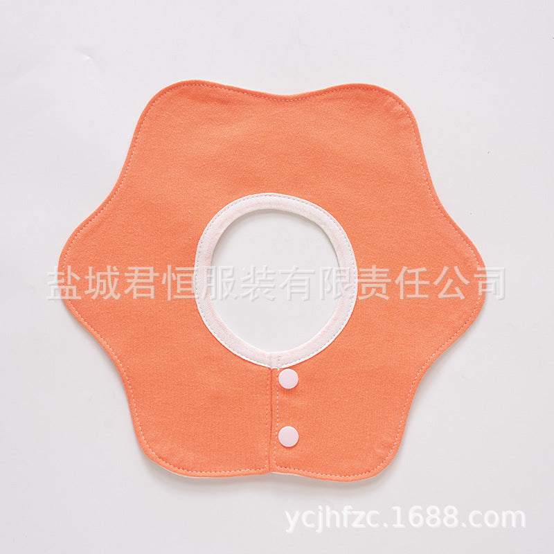 Orange fabric collar with white buttons on a light gray background