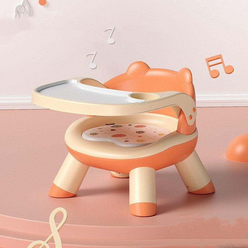 Children's learning chair with a tray on a pink background