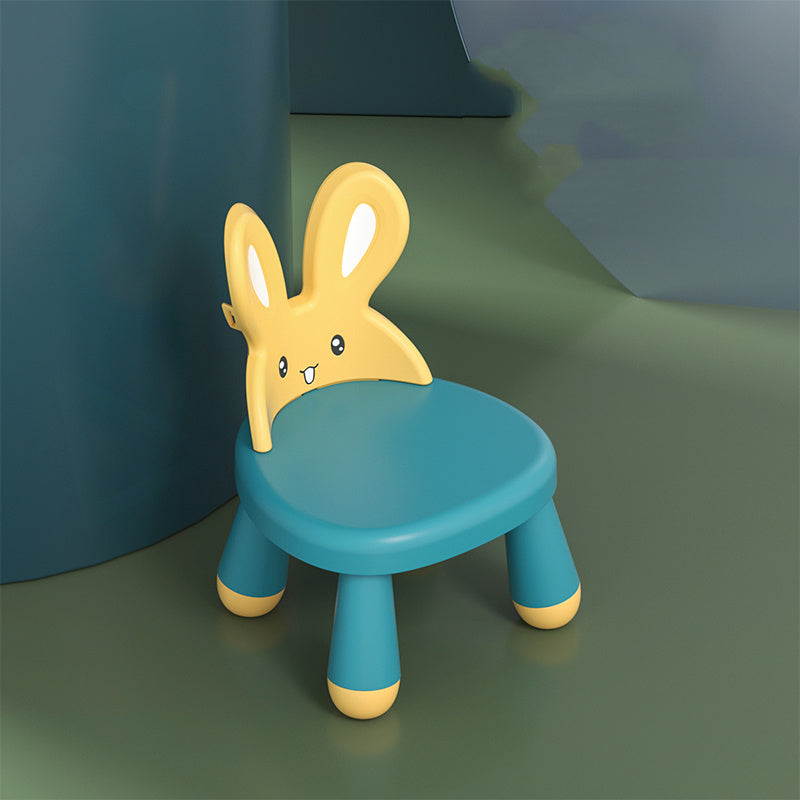 Children's chair with bunny design on a green floor against a blue wall