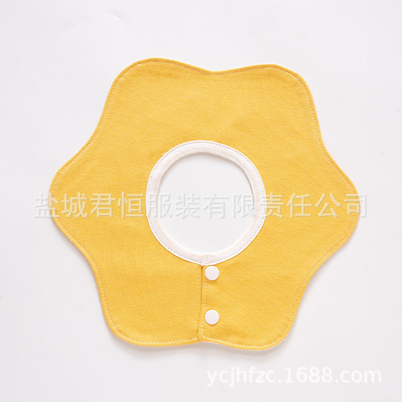 Yellow bib with white buttons on a light gray background