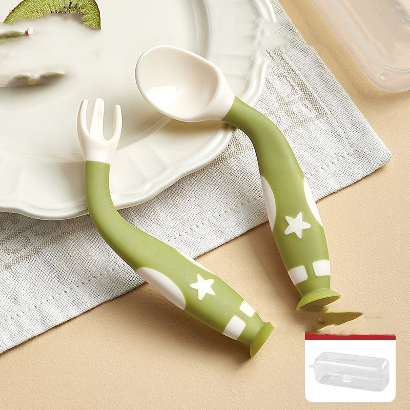 Children's fork and spoon set with green handles on a beige surface