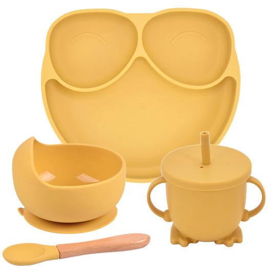 Yellow silicone dining set with plate, bowl, cup, and spoon on a white background