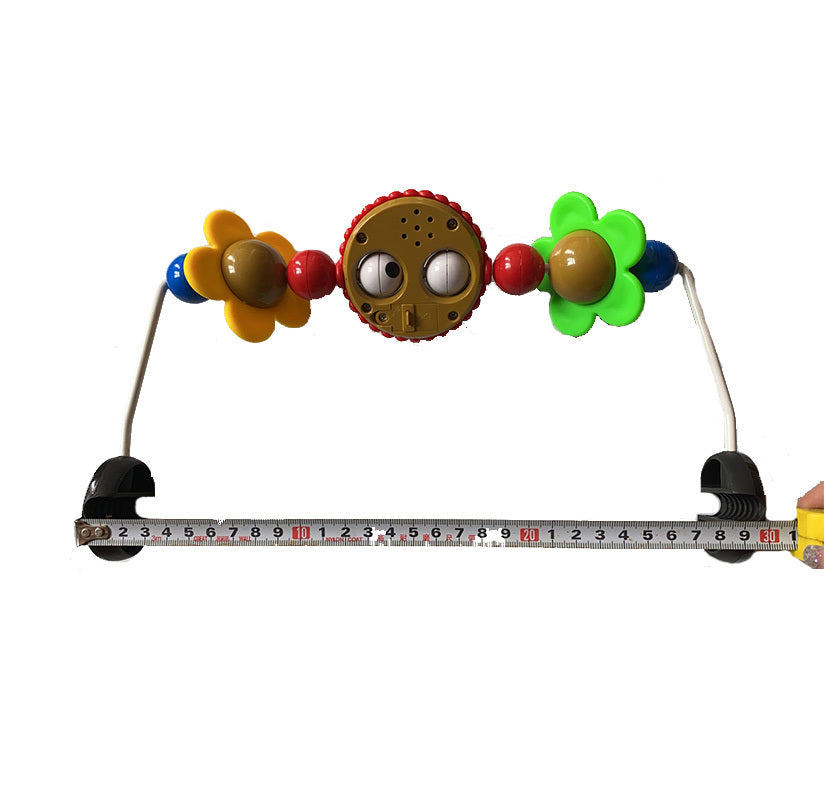 Colorful baby teething toy with a ruler for scale on a white background