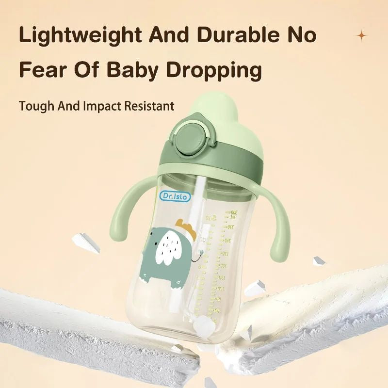 Green baby bottle with a cartoon design on a beige background