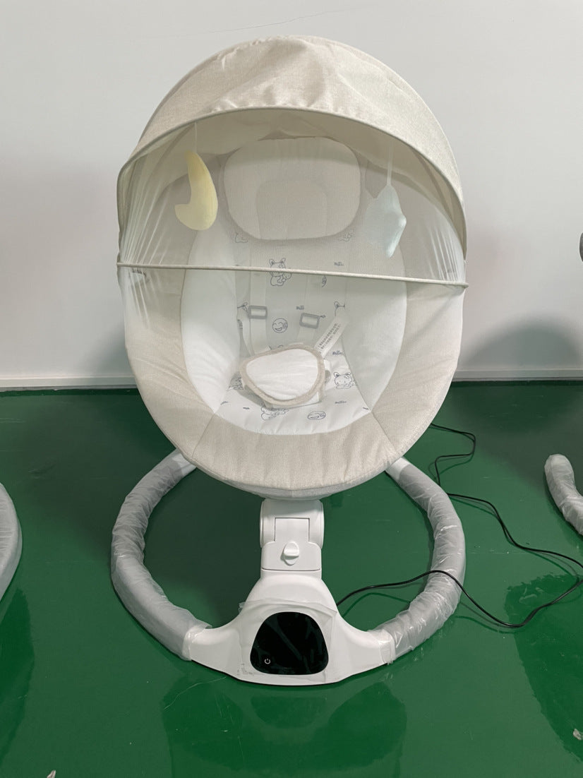 White baby swing with canopy on a green surface