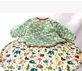 Children's bib with a green checkered pattern on a white background