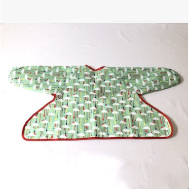 Green patterned garment cover with red trim on a white background