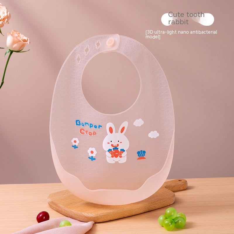 Children's silicone bib with cartoon design on a wooden stand against a pink background