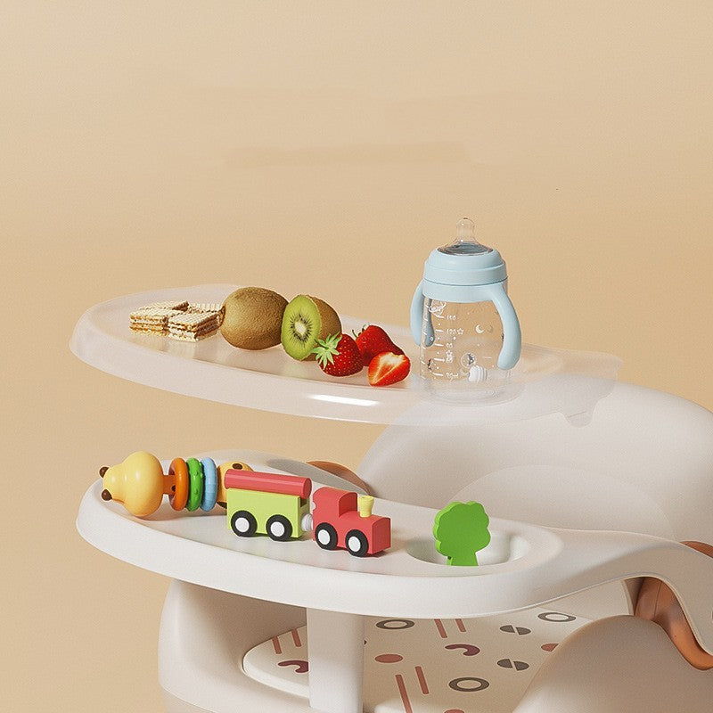 White tiered tray with toys, fruits, and a bottle on a beige background