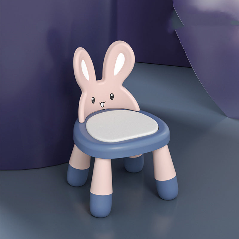 Children's chair designed like a rabbit with a blue base and pink body on a dark background