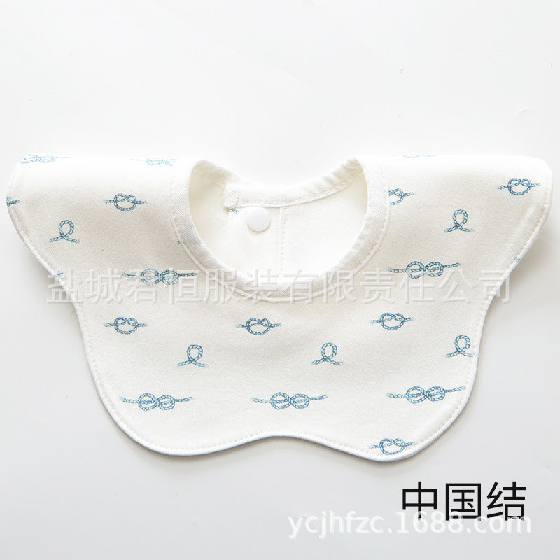 White baby bib with blue patterns on a white background