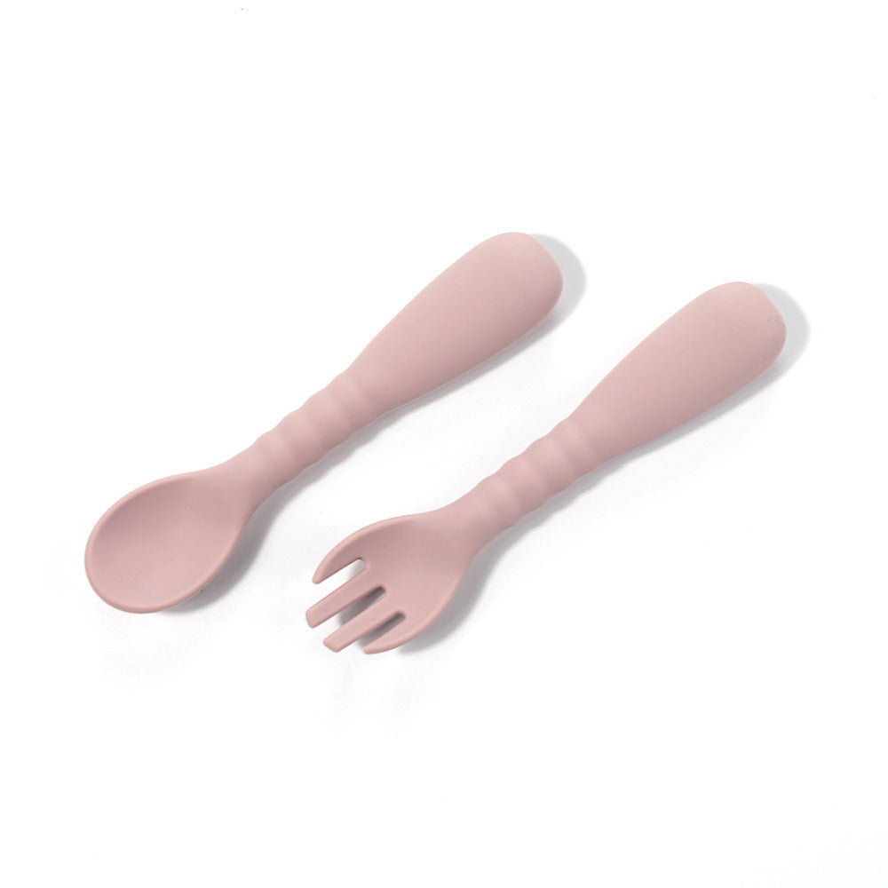 Pink spoon and fork set on a white background