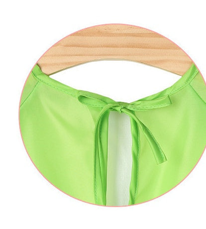 Green bikini top with a wooden ring on a white background