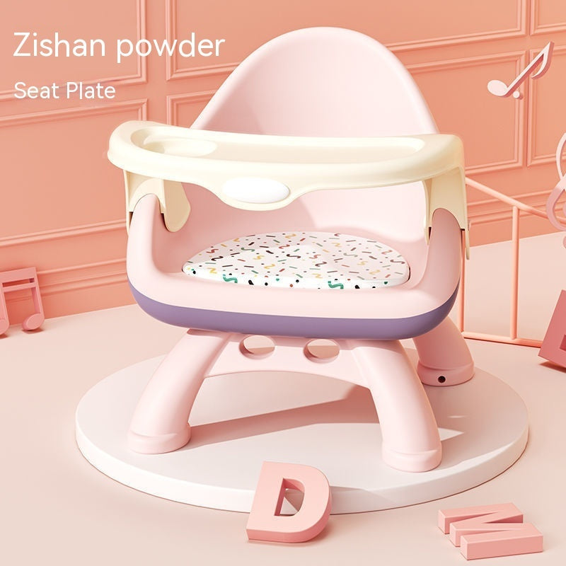 Pink and white baby seat with colorful seat plate on a pink background