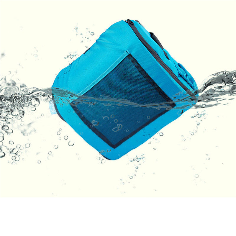 Blue waterproof bag with water splashing around it on a white background