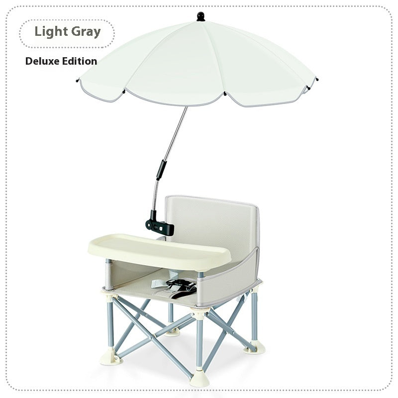 Light gray folding chair with a white umbrella and attached tray on a white background