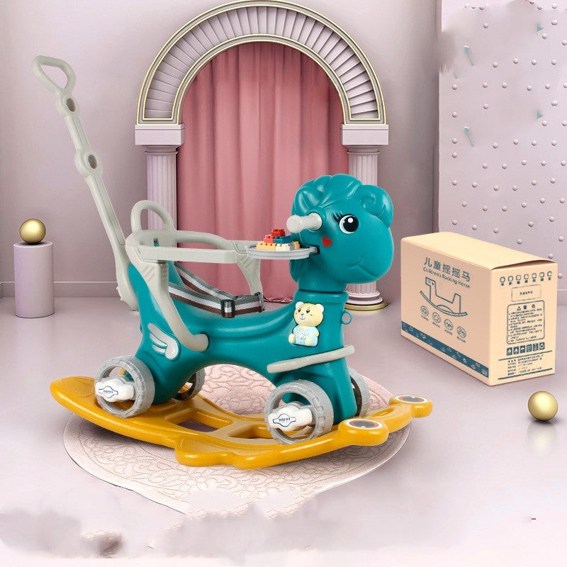 Toy horse with a yellow saddle on a white surface, next to a cardboard box.