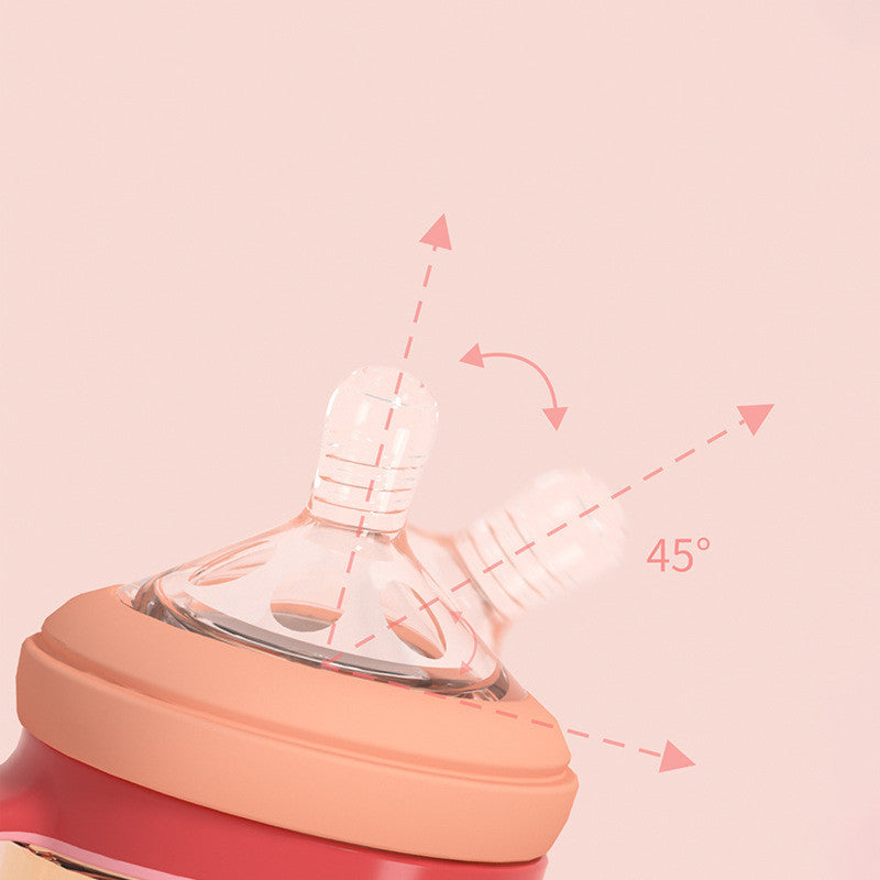 Close-up of a baby bottle with a pink background