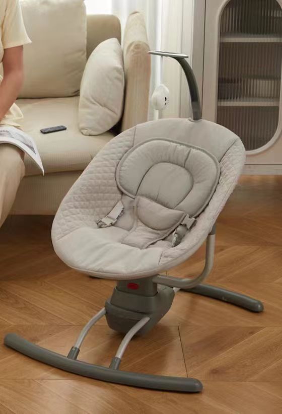 Baby swing on a wooden floor with a blurred background