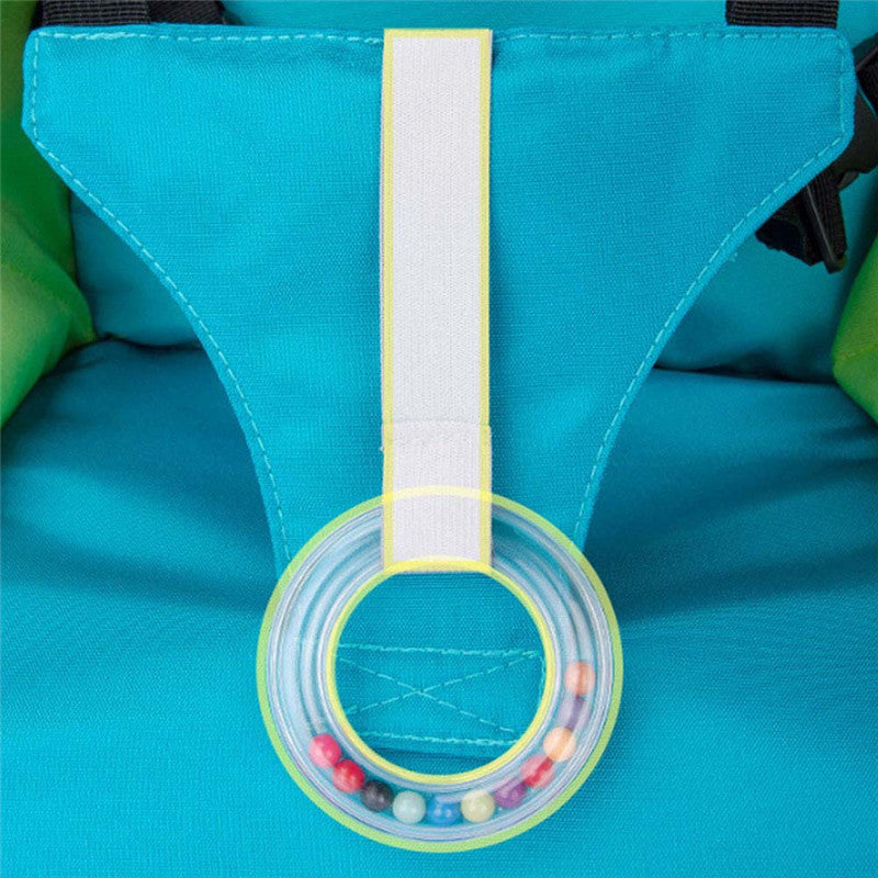 Close-up of a blue bag with a colorful bead holder attached, on a matching blue background.