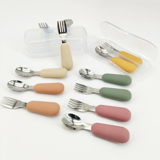 Set of colorful children's cutlery with handles on a white background
