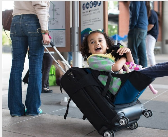 Child playing with a suitcase in an indoor setting