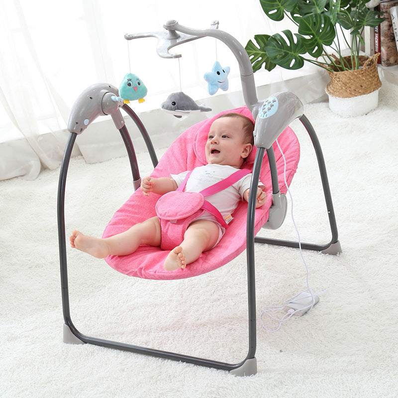 Baby in a pink baby swing with toys in a room setting