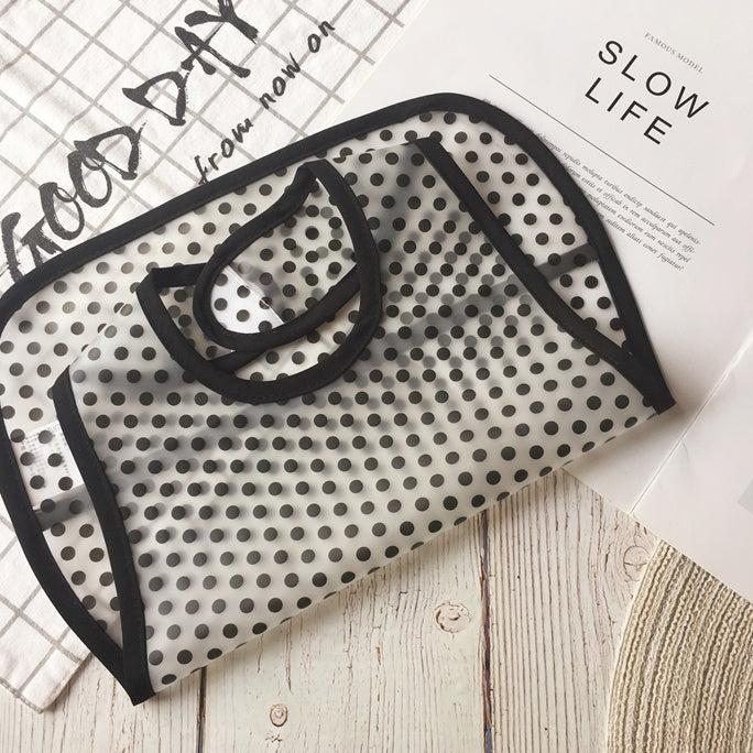 Black and white polka dot face mask on a newspaper with 'Good Day' and 'Slow Life' text.
