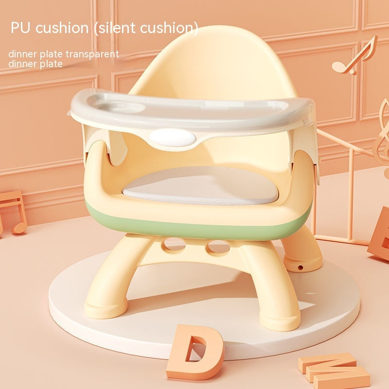 Children's high chair with PU cushion and transparent dinner plate on a peach-colored background