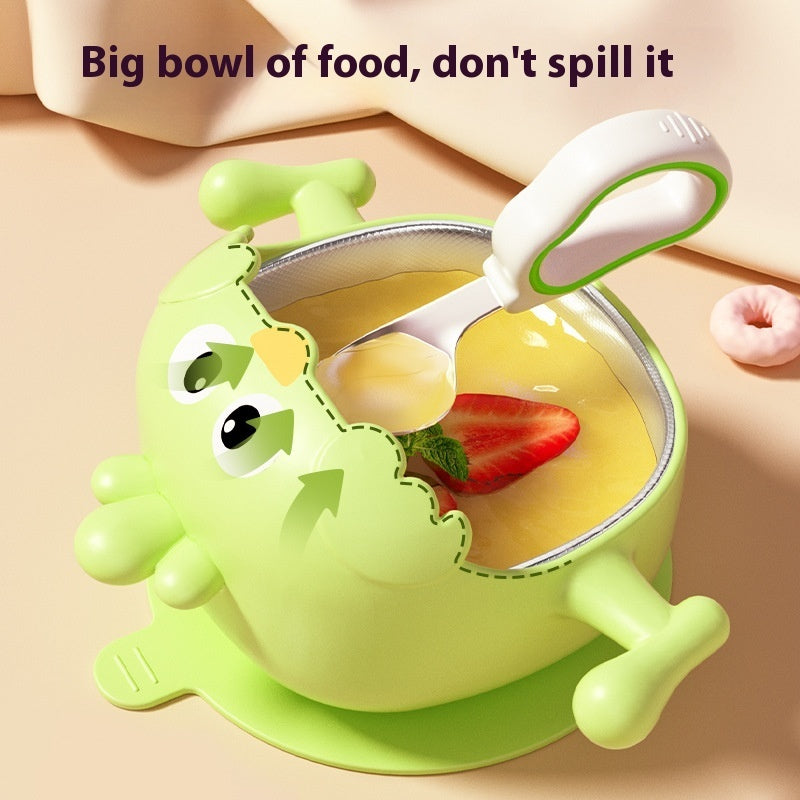 Green children's bowl with spoon and cartoon face, containing a dessert with strawberries.