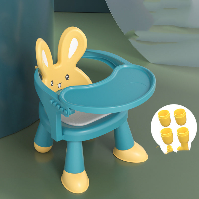 Children's potty training seat with bunny design on a green surface